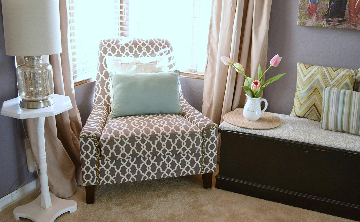 bedroomseating_sidetable.jpg upholstered chair next to side table in the bedroom